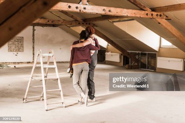 young couple renovating their new home, looking at construction site - attic conversion stock pictures, royalty-free photos & images