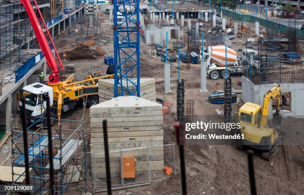 concrete pump and other machinery on construction site - betonmischer stock-fotos und bilder