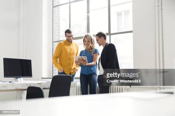 colleagues having a meeting in office - three people standing stock pictures, royalty-free photos & images