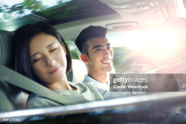 young couple driving on trip - asian couple car stockfoto's en -beelden