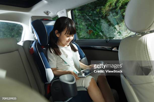 girl in car - child car tablet ストックフォトと画像