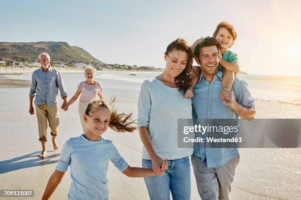 south africa, cape town, three generations family strolling on the beach - two generation family stock pictures, royalty-free photos & images