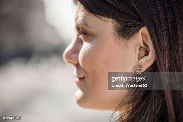 young woman with hearing aid, close-up - ear close up women stock-fotos und bilder