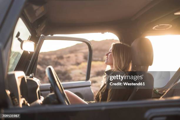 woman sitting in car at sunset - car interior side stock pictures, royalty-free photos & images