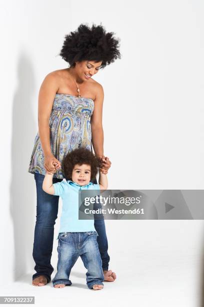 portrait of little boy with his pregnant mother - mother on white background stock pictures, royalty-free photos & images