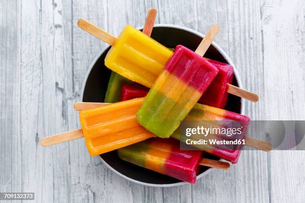 bowl of various homemade fruit smoothie ice lollies - sorbetto stock pictures, royalty-free photos & images