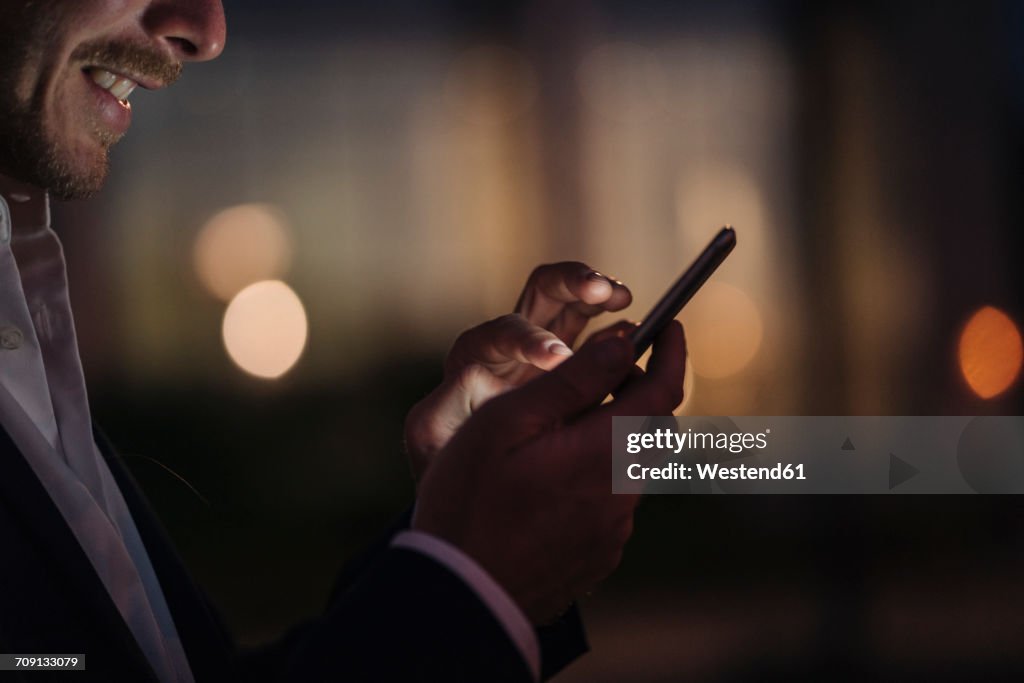 Close-up of businessman text messaging