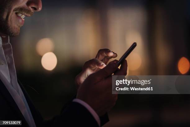 close-up of businessman text messaging - dark cells stock pictures, royalty-free photos & images