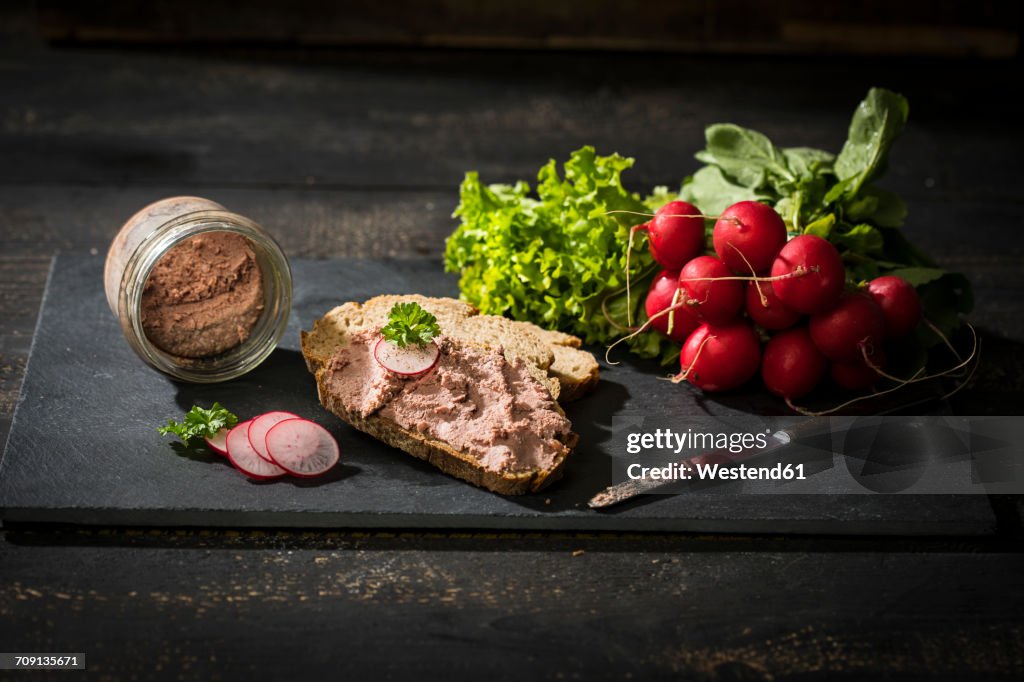 Liverwurst spread on slice of brown bread