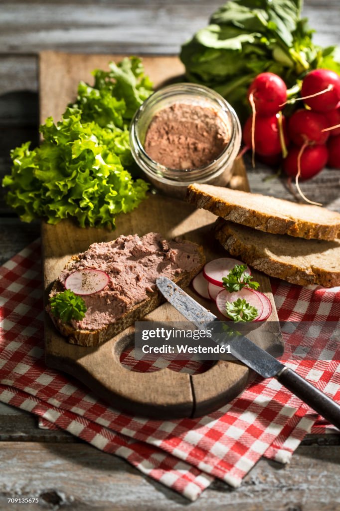 Liverwurst spread on slice of brown bread