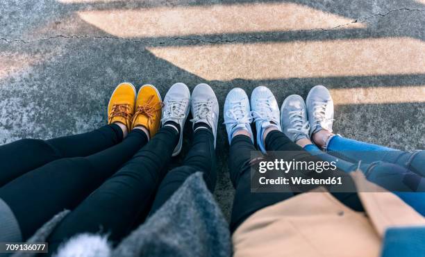 legs of four friends standing side by side - waistdown stock pictures, royalty-free photos & images