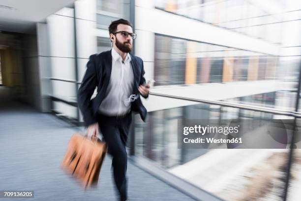 businessman running in corridor of an office building - 迫切 個照片及圖片檔
