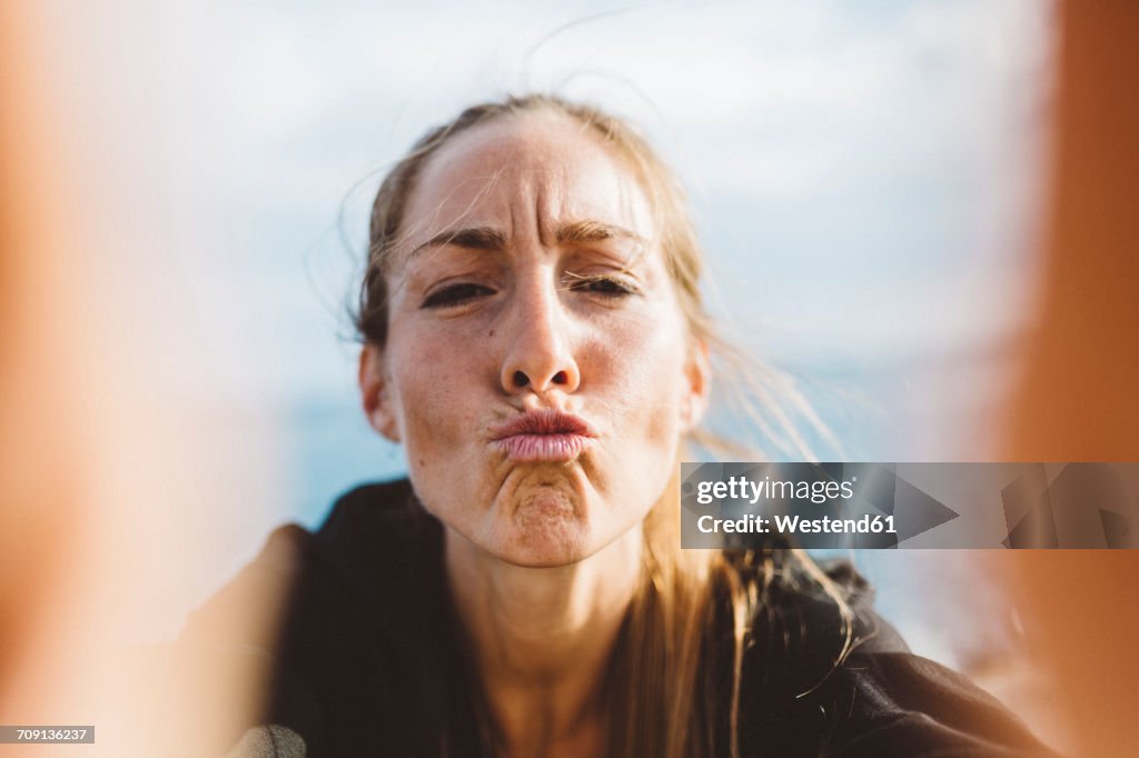 Selfie of young woman pouting