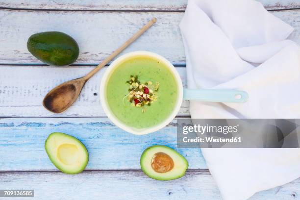 saucepan of avocado cucumber soup garnished with sprouts - gurke stock-fotos und bilder