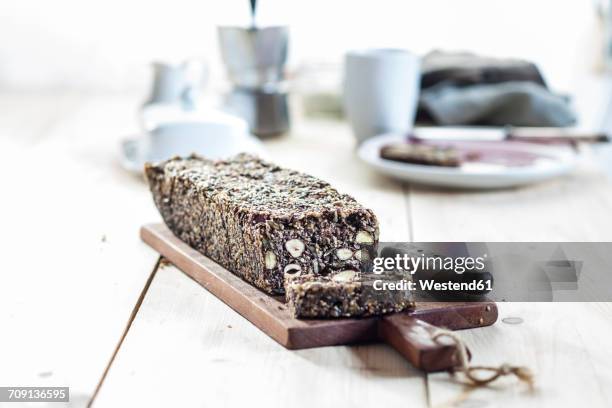 home-baked wholemeal gluten-ree bread with nuts and seeds on wooden board - low carb diet stock pictures, royalty-free photos & images