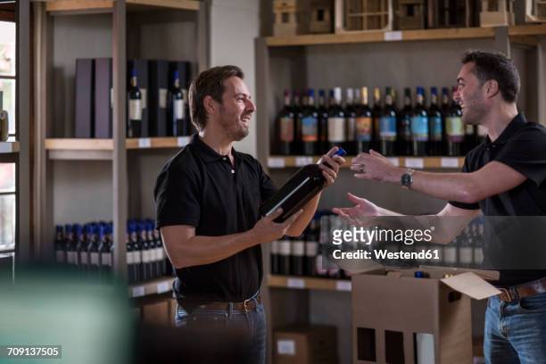 two men with wine bottle in shop - vinger bildbanksfoton och bilder