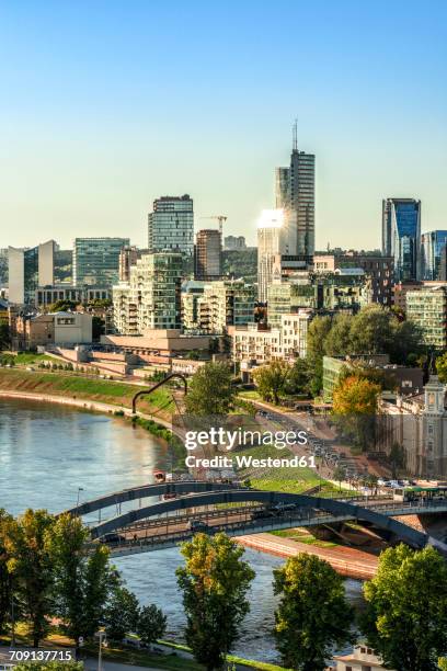 lithuania, vilnius, view to the modern city of vilnius with europa tower and neris river in the foreground - vilnius stock pictures, royalty-free photos & images