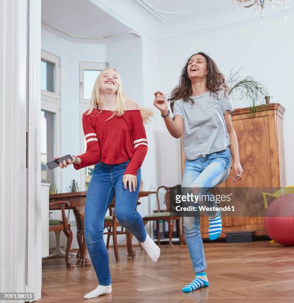 Two girls dancing at home