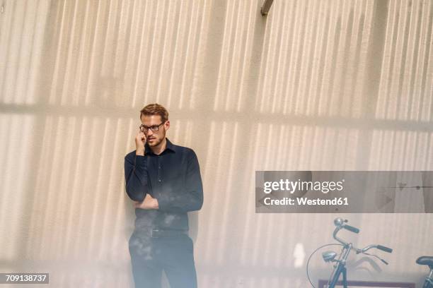 businessman talking on cell phone - pessimism stock pictures, royalty-free photos & images