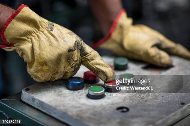 hand operating control panel - guantes-de-trabajo fotografías e imágenes de stock