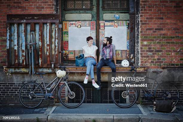 couple with electric bicycles - hamburg stock-fotos und bilder