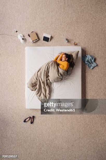 woman lying in bed, top view - schuhe frau von oben stock-fotos und bilder