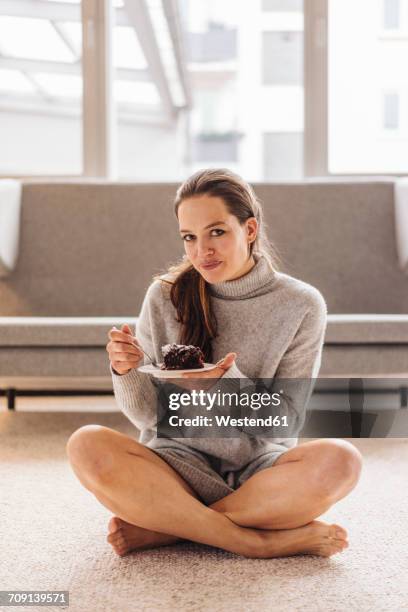 portrait of woman sitting on floor eating piece of cake - cake top view stock pictures, royalty-free photos & images