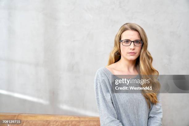 portrait of serious blond woman wearing glases - unhappy woman blonde glasses stock pictures, royalty-free photos & images