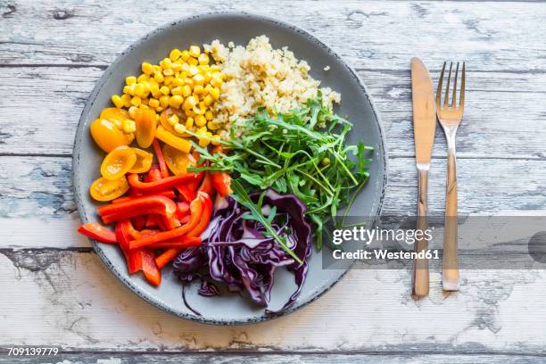 plate of rainbow salad with bulgur, rocket and different vegetables - salad bowl stock pictures, royalty-free photos & images