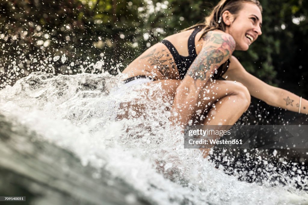 Indonesia, Java, happy woman surfing