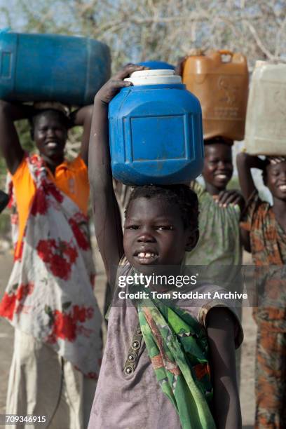 Women and children photographed collecting water at Wara village in Pariang County in Unity State, South Sudan where the International Committee of...