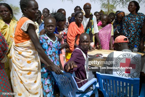 People photographed registering in Abathok village during an International Committee of the Red Cross distribution of seeds, agricultural tools and...