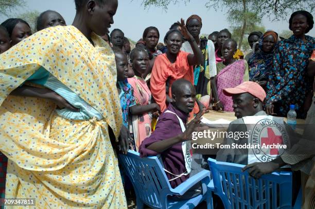 People photographed registering in Abathok village during an International Committee of the Red Cross distribution of seeds, agricultural tools and...