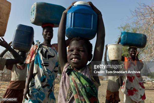 Women and children collect water at Wara village in Pariang County in Unity State, South Sudan where the International Committee of the Red Cross...