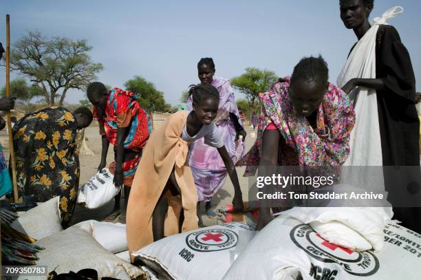 Scene during an International Committee of the Red Cross distribution of seeds, agricultural tools and food staples to households in villages around...