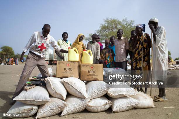 Women photographed during an International Committee of the Red Cross distribution of seeds, agricultural tools and food staples to households in...