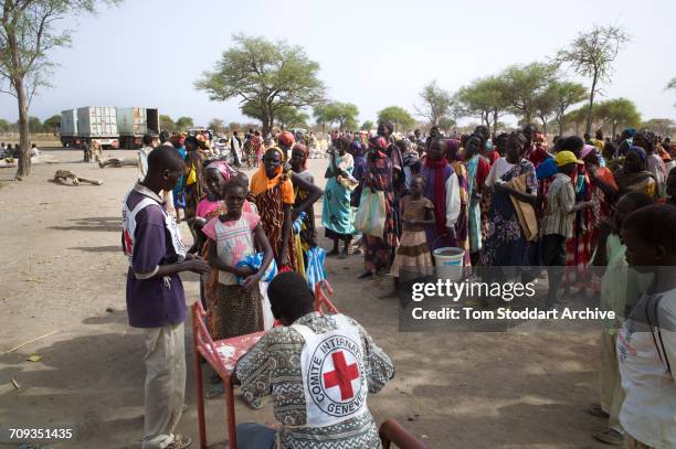 Scene during an International Committee of the Red Cross distribution of seeds, agricultural tools and food staples to households in villages around...