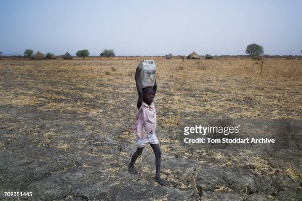 Women and children collect water at Wengoth village in Pariang County in Unity State, South Sudan where the International Committee of the Red Cross...
