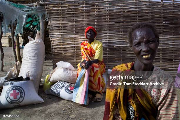 Scene in Nyintar village during an International Committee of the Red Cross distribution of seeds, agricultural tools and food staples to households...
