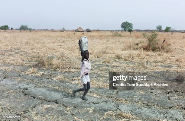 Women and children collect water at Wengoth village in Pariang County in Unity State, South Sudan where the International Committee of the Red Cross...