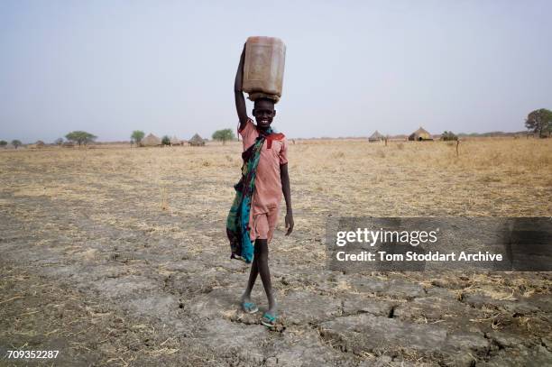 Women and children collect water at Wengoth village in Pariang County in Unity State, South Sudan where the International Committee of the Red Cross...