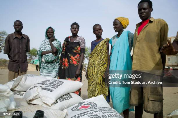 Scene in Nyintar village during an International Committee of the Red Cross distribution of seeds, agricultural tools and food staples to households...