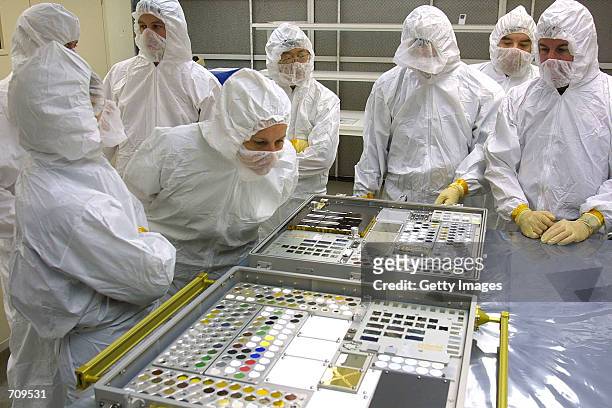 Eileen Collins , Mission Commander for NASA shuttle flight STS-114, inspects one of the Passive Experiment Containers in a clean room at the NASA...