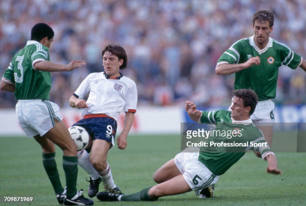 English footballer Peter Beardsley is tackled for the ball by Republic of Ireland players Chris Hughton and Kevin Moran as Mick McCarthy runs to...
