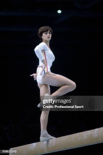 Romanian gymnast Nadia Comaneci pictured in action to win the gold medal on the balance beam during competition in the women's artistic team...