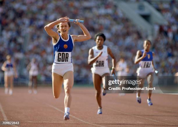 East German athlete Marlies Gohr crosses the finish line in first place to win the gold medal for the East Germany team ahead of Sonia Lannaman of...