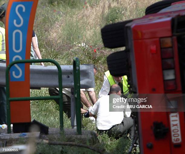 Rescue teams work at the scene of a bus accident on the A1 highway in Pedrezuela, near Madrid, 21 May 2006. A bus with a Belgian number plate veered...