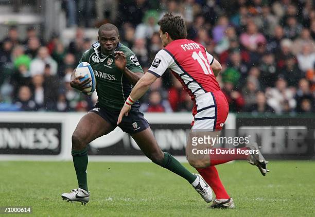 Topsy Ojo of London Irish tries to elude the tackle of Mark Foster of Gloucester during the European Challenge Cup Final match between Gloucester and...