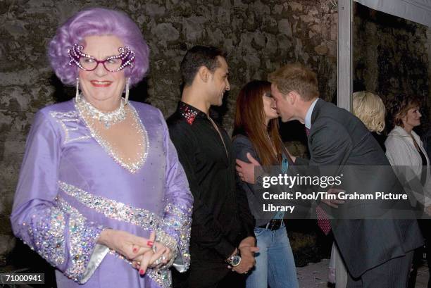 Barry Humphries as Dame Edna Everage smiling as Prince William greets pop star Natasha Hamilton with a kiss at the live pop concert to mark the 30th...