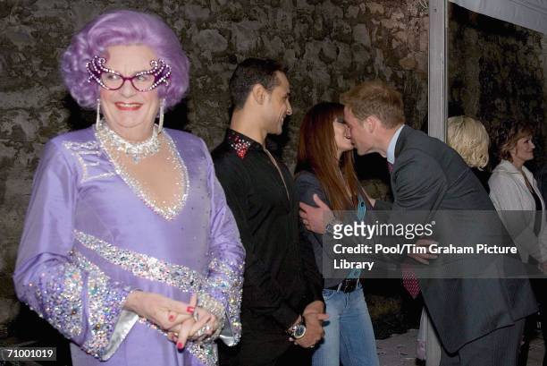 Barry Humphries as Dame Edna Everage smiling as Prince William greets pop star Natasha Hamilton with a kiss at the live pop concert to mark the 30th...